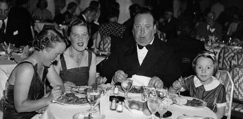 Hitchcock dining in a New York restaurant in August 1937 with his wife Alma, assistant Joan Harrison, and daughter Patricia.