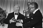 Alfred Hitchcock (1968) - Photograph of Hitchcock accepting the Thalberg Award from director Robert Wise at the 1968 Academy Awards.