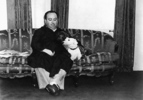 Hitchcock - Photograph of Alfred Hitchcock relaxing with one of his pet Sealyham Terriers.