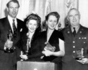 Suspicion (1941) - photograph - Photograph of Joan Fontaine at the 14th Academy Awards ceremony, held in February 1942. Fontaine won the Oscar for Best Actress for her role in ''Suspicion'' (1941). L-R: Gary Cooper, Fontaine, Mary Astor and Donald Crisp.