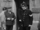 YOUNG AND INNOCENT (1937) - FILM FRAME - Film frame from ''Young and Innocent'' (1937) showing Hitchcock's cameo appearance as a photographer outside the police court.