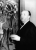 Alfred Hitchcock (1944) - Photograph of Alfred Hitchcock standing beside Salvador Dali's painting ''Movies'', taken by photographer Herbert Gehr in the lobby of the Ziegfeld Theater, New York. Hitchcock was attending the Cole Porter musical review ''The Seven Lively Arts''.